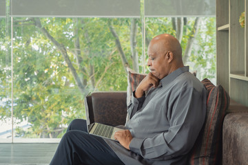 Business elderly black american man, African person working from home, thinking about problem with...