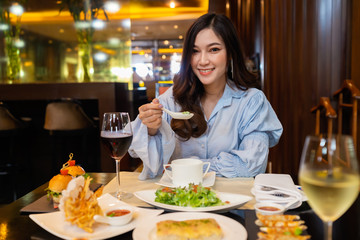 Young woman eating in the restaurant