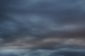 storm clouds in grey, blue and orange stripes, for background 