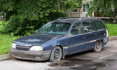 Abandoned old broken car with flat wheels, Iskrovsky Prospekt, Saint Petersburg, Russia, August 2020