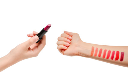 Lipstick swatches on woman hand isolated.