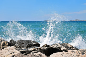 Sea wave is breaking on a rock. Blue sky and the azure sea. Marseille, France