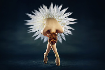 young ballerina against a black background