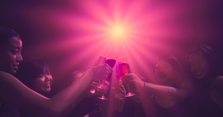 friends enjoy party in nightclub and toasting wine together