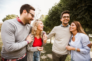 Fototapeta premium Group of young people walking through park. Friends having fun outdoor