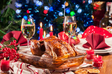 Baked or roasted whole chicken on Christmas table