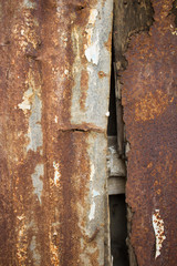 evocative image of rusty metal sheets nailed to old wooden beams