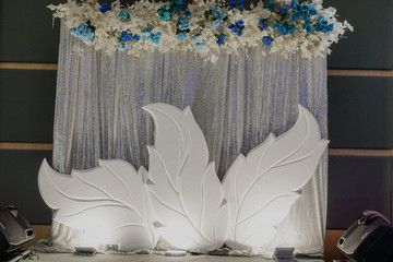 luxury wedding photo corner background with hanging white and blue flower wedding decoration ballroom with standing flower