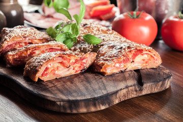 Italian stromboli stuffed with ham, salami and cheese