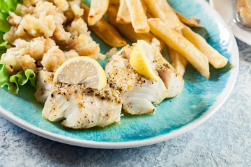 Steamed cod fish with french fries and boiled cauliflower
