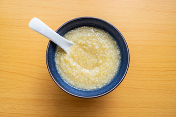 Millet porridge in a bowl on wooden table