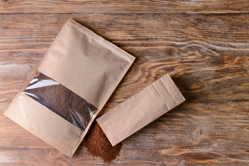 Bags with coffee powder on table