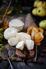 Farmer camembert cheese on the cutting board. selective focus