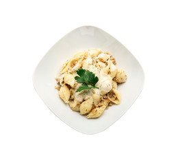 Plate with tasty conchiglie pasta on white background