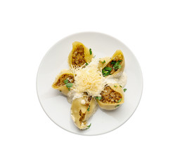 Plate with tasty conchiglioni pasta on white background