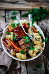 pork ribs with cauliflower and carrots..style rustic.