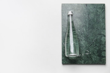 Bottle of clean water on light background