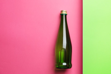Bottle of clean water on color background
