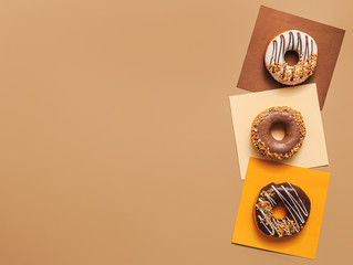 Sweet tasty donuts on color background