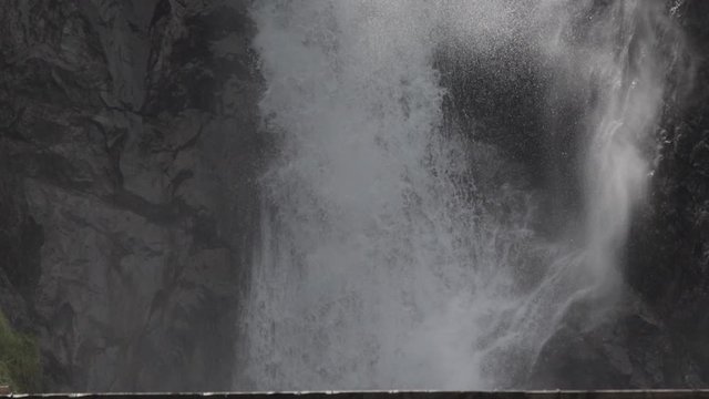 Smooth pan up in slowmotion of the La Pisse waterfall. French Alps. Pro Res