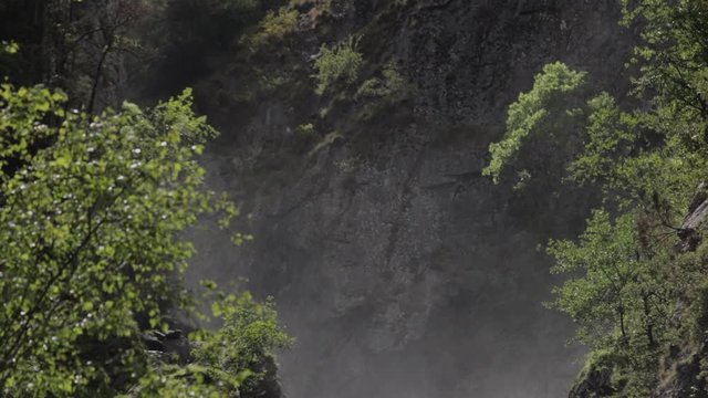 Pan down slowmotion shot of the La Pisse waterfall. French Alps. Pro Res
