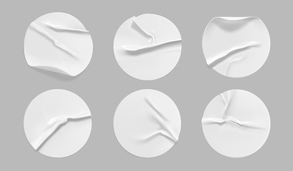 White round crumpled sticker mock up set. Adhesive white paper or plastic sticker label with glued, wrinkled effect on gray background. Blank templates of a label or price tags. 3d realistic vector