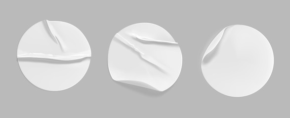 White round crumpled sticker mock up set. Adhesive white paper or plastic sticker label with glued, wrinkled effect on gray background. Blank templates of a label or price tags. 3d realistic vector