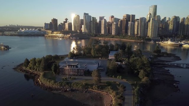 HMCS Discovery Canadian Navy Reserve On Deadman's Island With The Vancouver Downtown Skyline And Coal Harbour On The Background On A Sunrise In British Columbia.  -aerial drone - slow panning