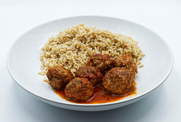 Meatballs with basmati rice on white dish isolated on white bckground