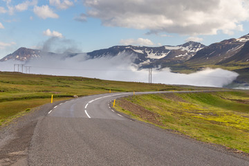 Road near Sedydisfjordur. Mountains in the background, East Iceland.