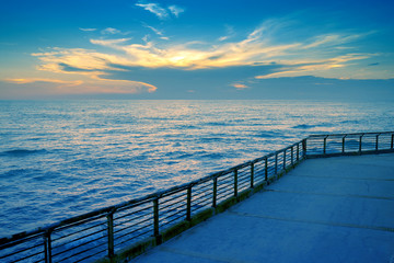 Fototapeta premium Seascape during sunset. The embankment on the beach