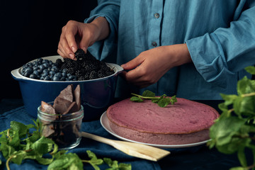 Woman prepare for decoration cottage cheese pie.