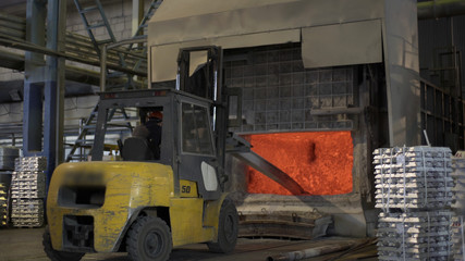 Loader mixing red-hot aluminium in bowl in aluminium plant. Aluminium foundry furnace loaded with metal. Blast furnace, in foundry in metallurgical plant, dark workshop and red-hot aluminium