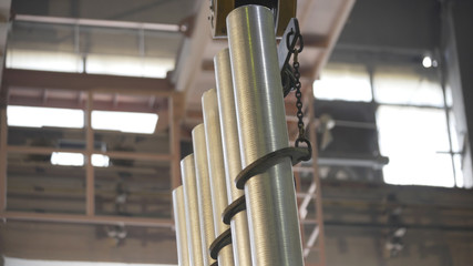 Forming aluminum pillar after melting in modern factory. Production of aluminium metal profiles, commonly used as material in construction and manufacturing.