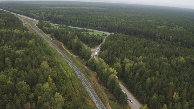 Sky view of summer road with cars and trucks. Summer forest and highway road drone view. Highway truck traffic © spocktv