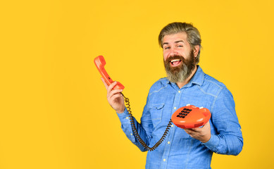hello 80s. Man with moustache holding vintage phone. vintage communication device. Businessman...