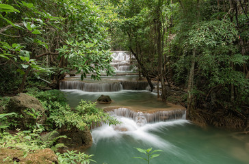 Huay Khamin waterfall with 7 levels located in Kanchanaburi in the midst of nature with green trees. Cold flowing water