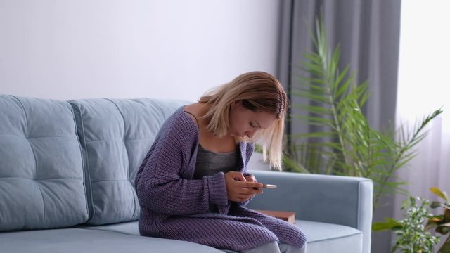 woman looking and using smart phone with scoliosis, side view. Incorrect posture, scoliosis, orthopedics concept. female with a smartphone in her hands demonstrates correct and incorrect posture