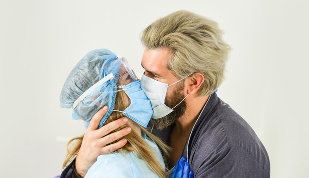 nurse woman kiss patient. avoid personal contact. coronavirus pandemic outbreak preventions. stay at home. man and doctor in respirator mask. Couple in love. protect your family. quarantine - Powered by Adobe