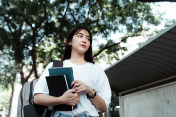 Girl with books and backpack.