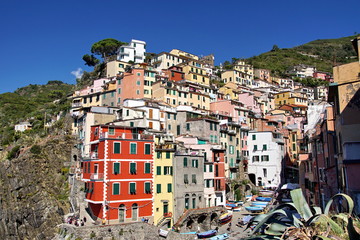 Fototapeta na wymiar Riomaggiore is an ancient village with colorful houses and a small port, one of the Cique Terre sequence of hill cities on the Mediterranean sea coast in Liguria, Italy