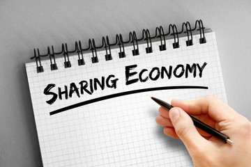 Sharing Economy text on notepad, business concept background