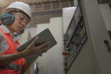 Woman engineering in charge of working duty in dashboard controller of the machine operation in...