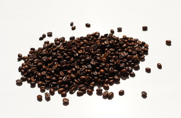 Textured background with arabica coffee beans and robusta closeup. Every day, people drink aromatic strong espresso in the morning. A popular world tradition in every country. Macro view backdrop 