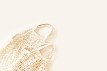 Zero waste minimal composition with tring and canvas bags for storage. Zero waste, eco friendly shopping. Mockup of small eco sack natural cotton fabric. Sustainable lifestyle.Top view, flat lay.