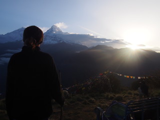 A woman looking great nature with sunrise, A hill station "Poon Hill" overlooking the Annapurna Massif range and Dhaulagiri mountain range, ABC (Annapurna Base Camp) Trek, Annapurna, Nepal