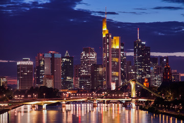 The illuminated skyline of Frankfurt am Main, Germany during the night with skyscrapers