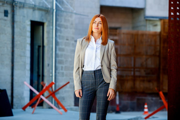 Confident business expert. Happy successful professional posing near office building. European girl. Russian business lady. Female business leader concept. Portrait Of Successful Business Woman