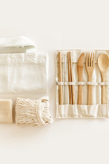 Eco friendly accessories - bamboo cutlery, eco bag, reusable water bottle. Zero waste, plastic free concept, sustainable lifestyle. Top view, flat lay.