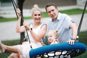 Family of three on a swing